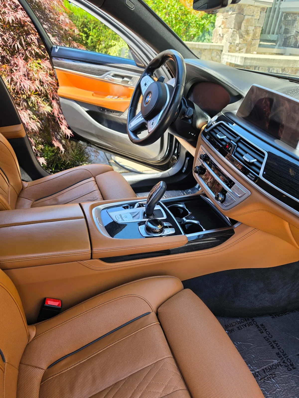 BMW 740i luxury sedan interior front seat with cognac leather after detailing