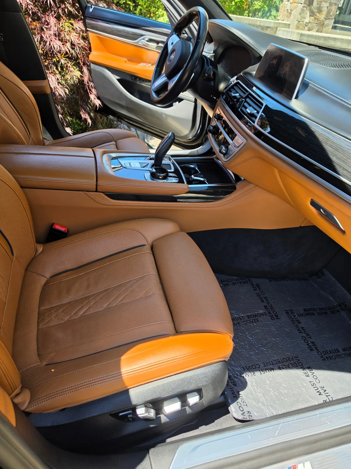 BMW 740i luxury sedan front passenger cabin with detailed leather seats