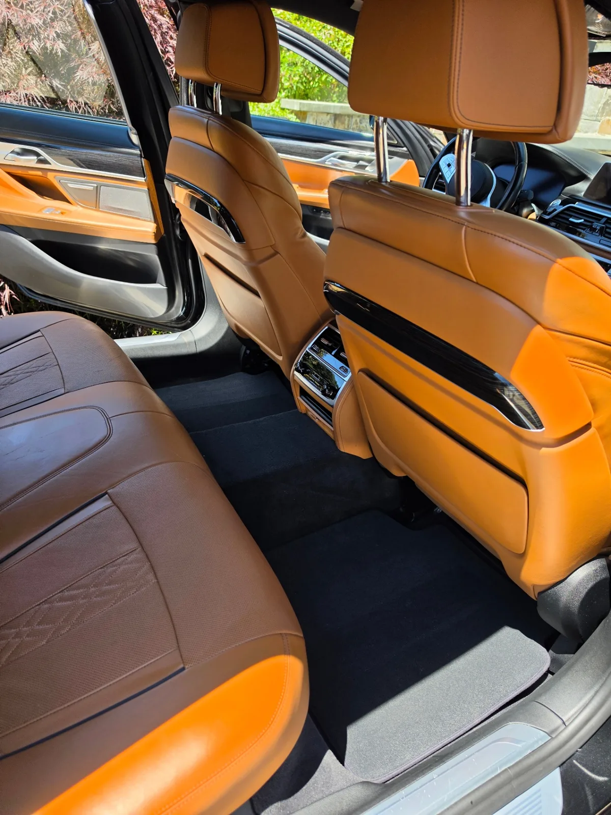 BMW 740i luxury sedan rear passenger seats with cognac leather after interior detailing