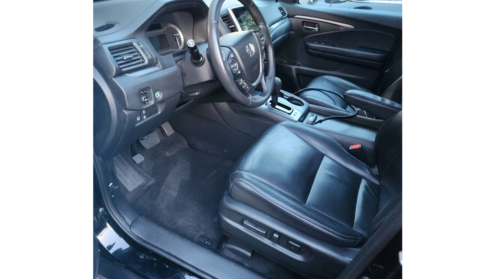 Black leather interior showing clean seats and dashboard