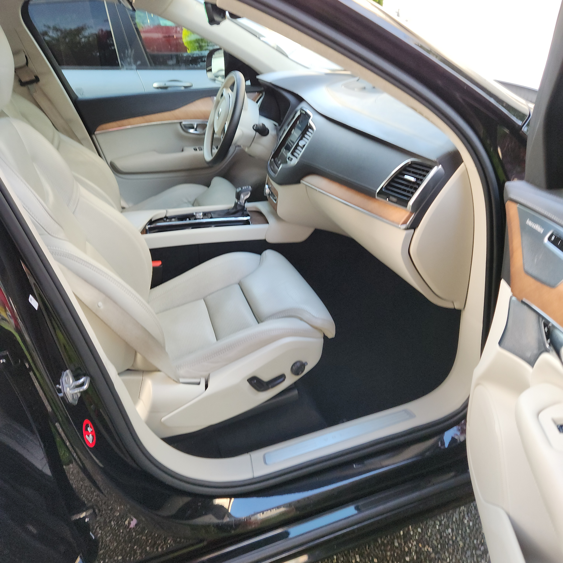 Luxury vehicle front driver area with cream leather