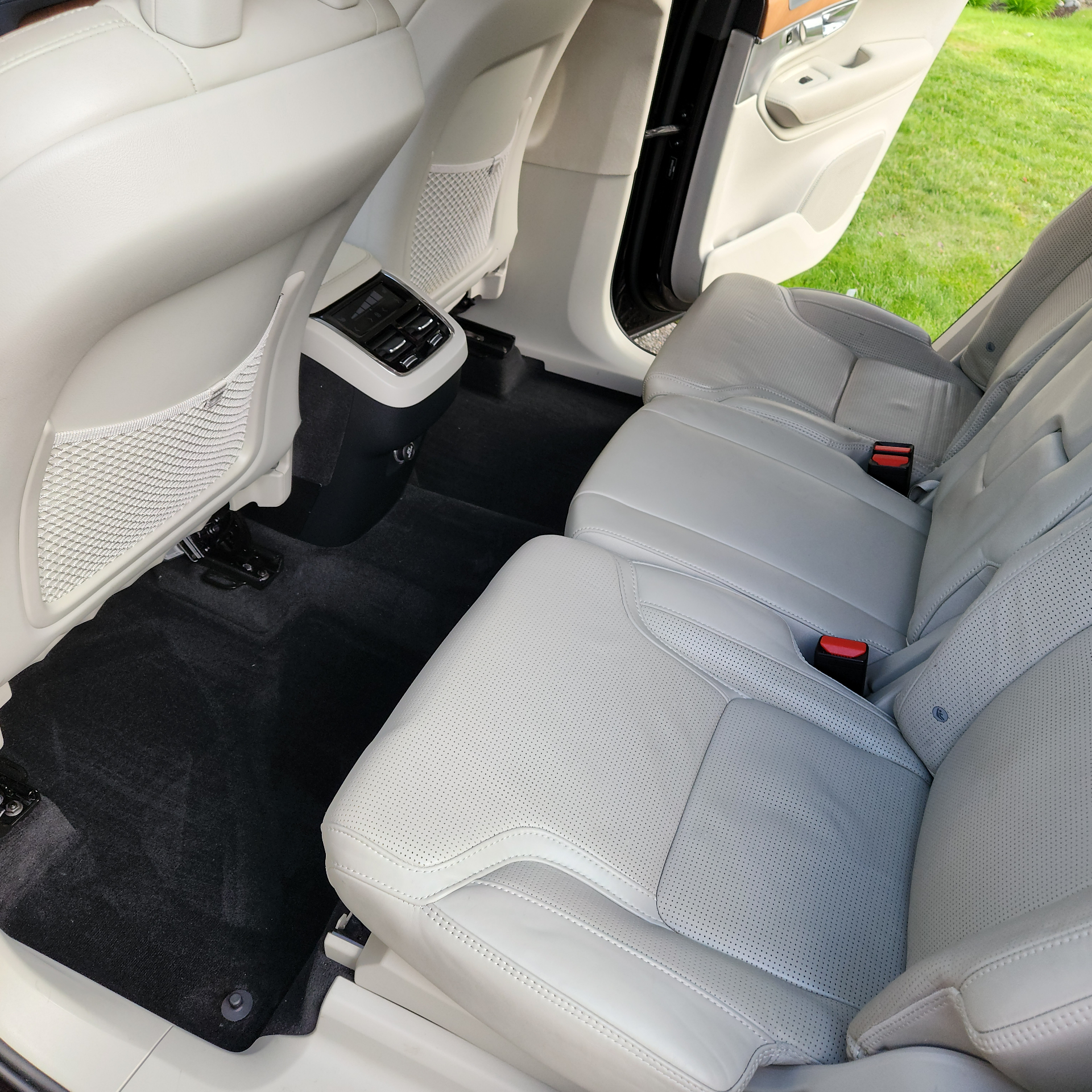 Rear passenger seating with light gray leather