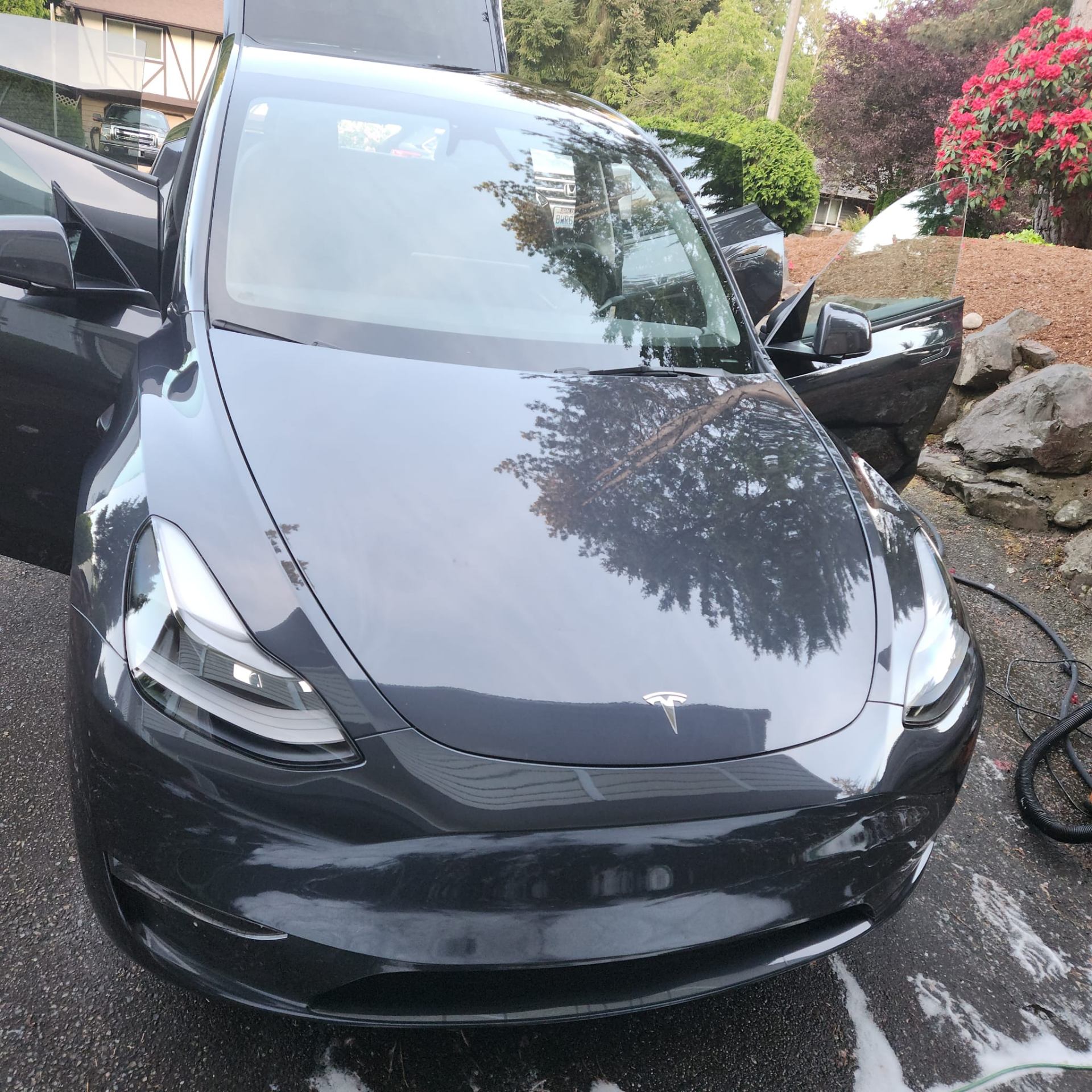 Black Tesla Model 3 with pristine finish after detailing